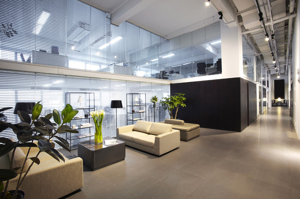reception area of office building with two tan couches and plants